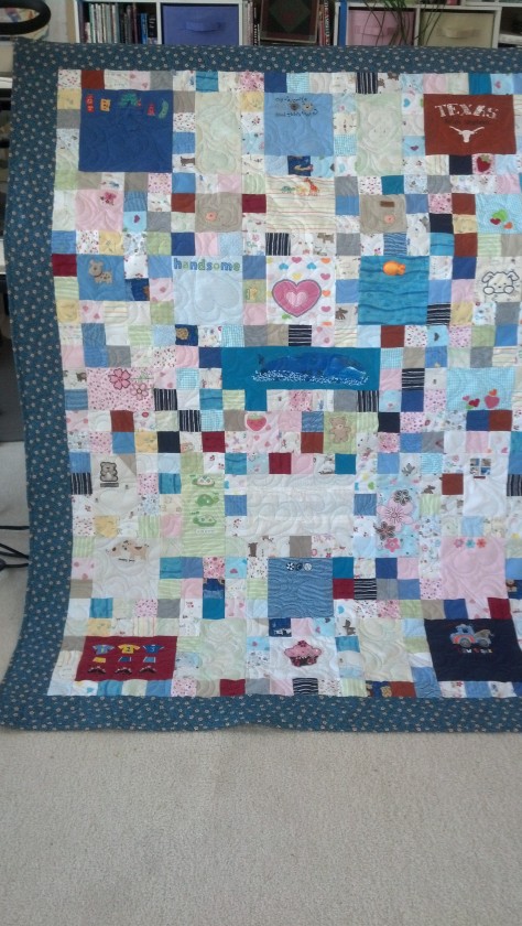 Baby clothing quilt with panels and 2" squares